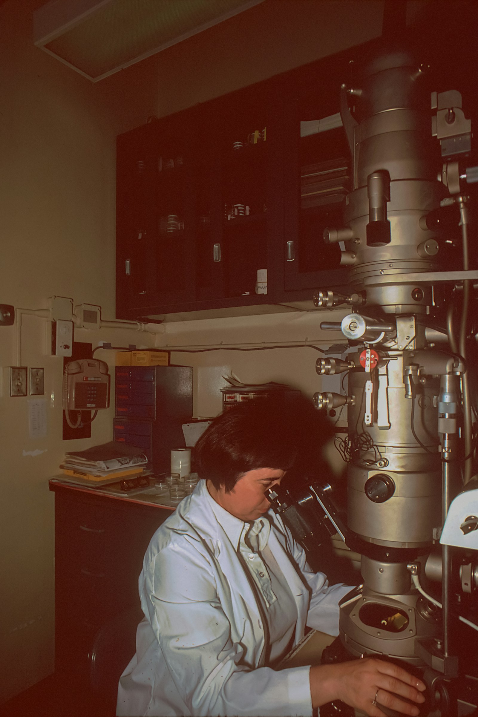 A scientist using an electron microscope in a laboratory